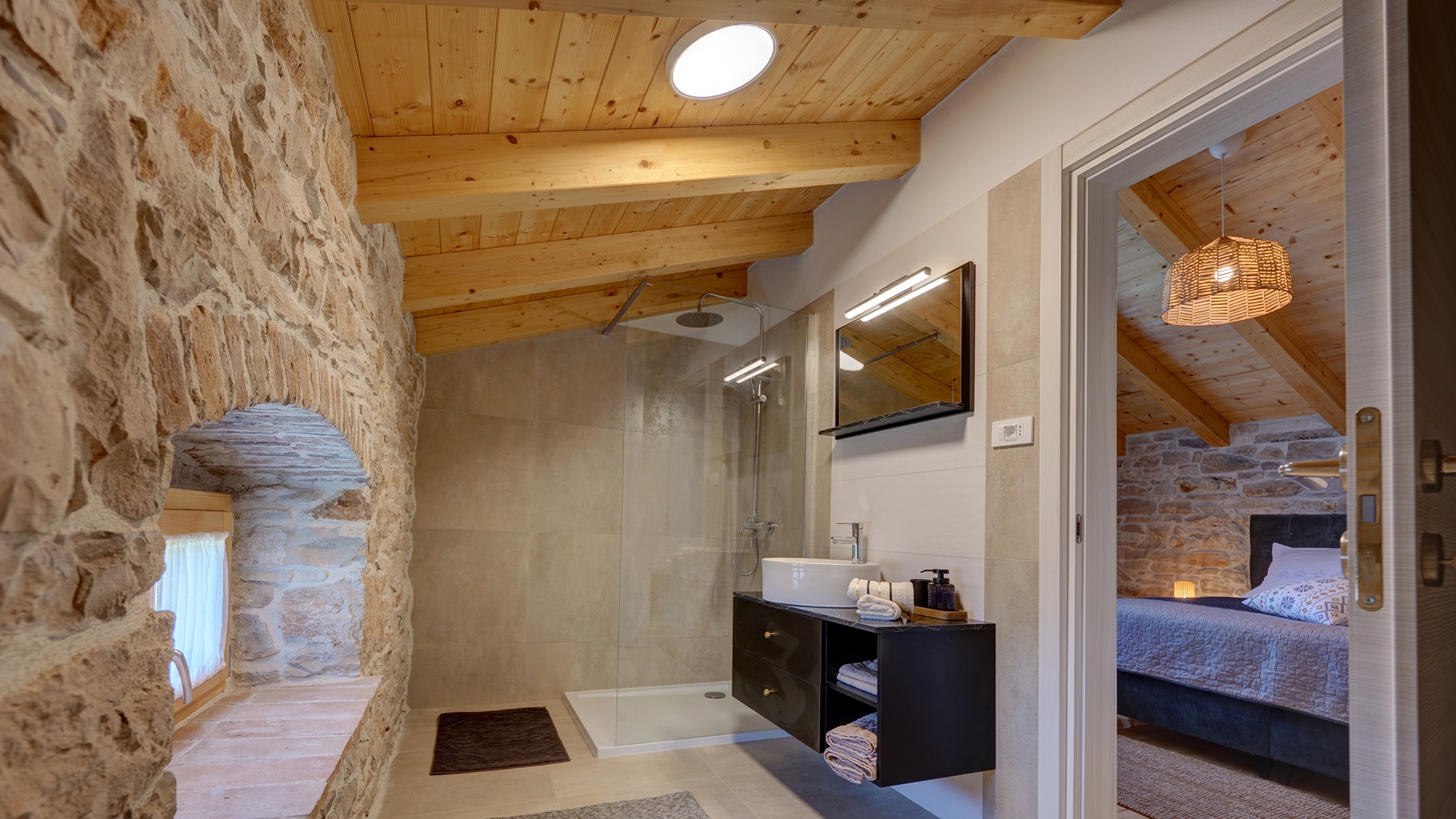 Bathroom 1 — shower, stone wall & skylight