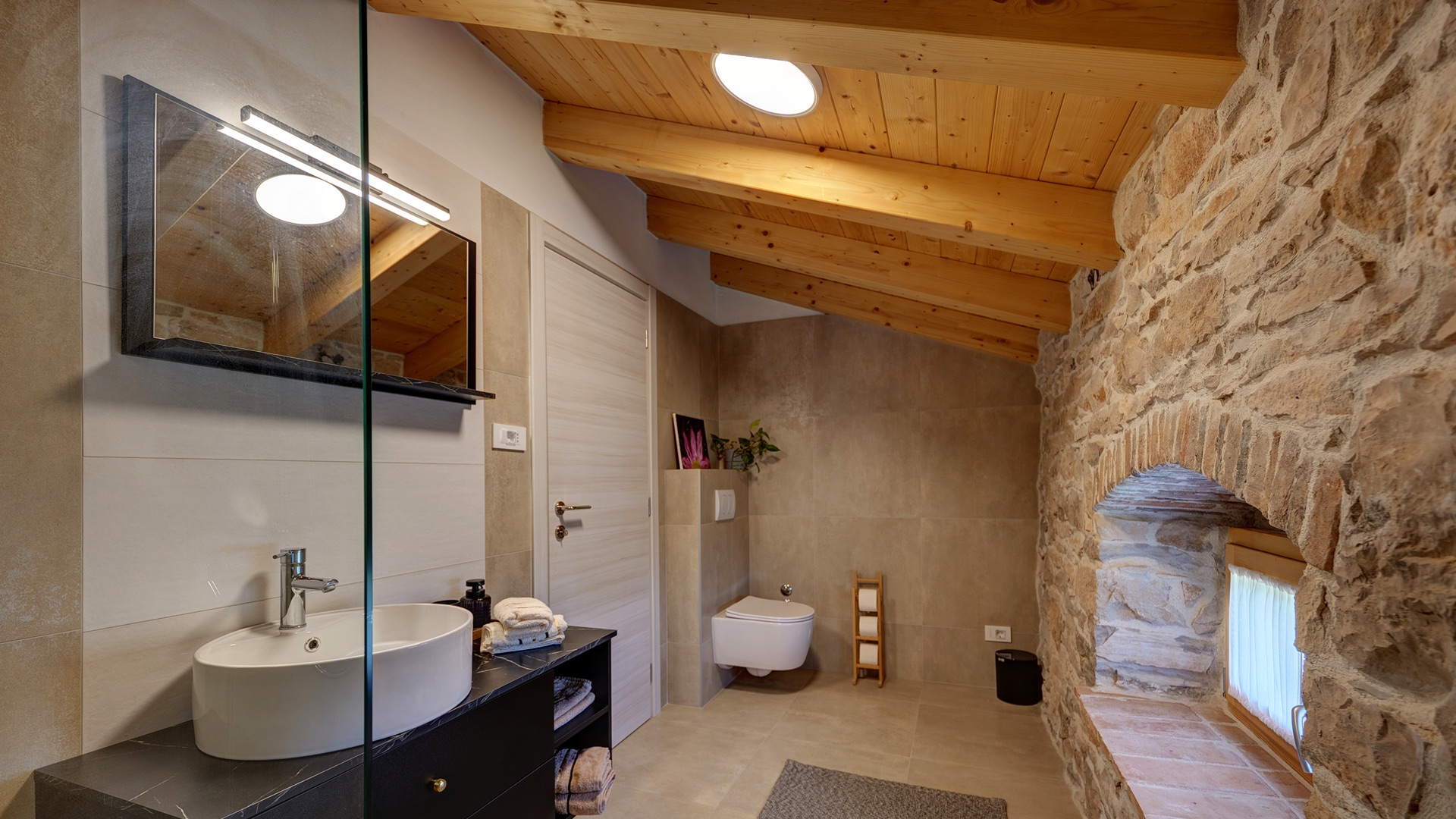 Bathroom 1 — vanity, toilet & stone arch