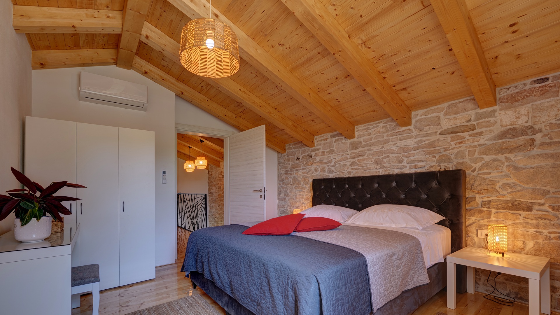 Bedroom 2 — king bed, stone wall & wardrobe