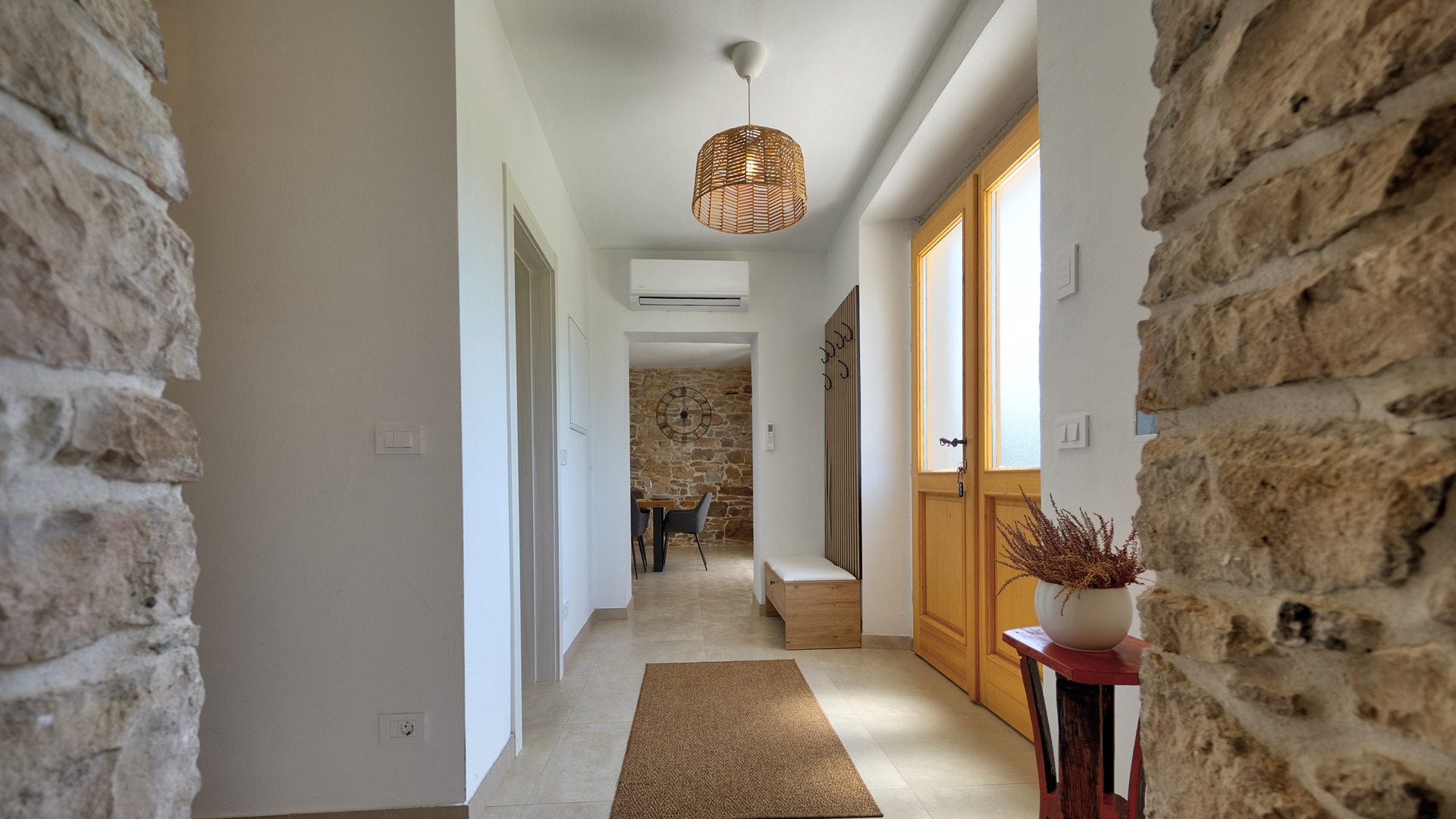 Entrance hall — wooden door & rattan pendant