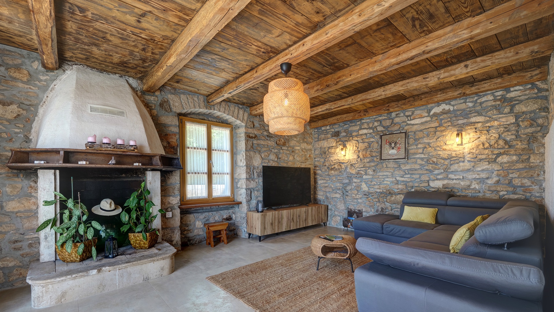 Living room — fireplace, TV & stone walls