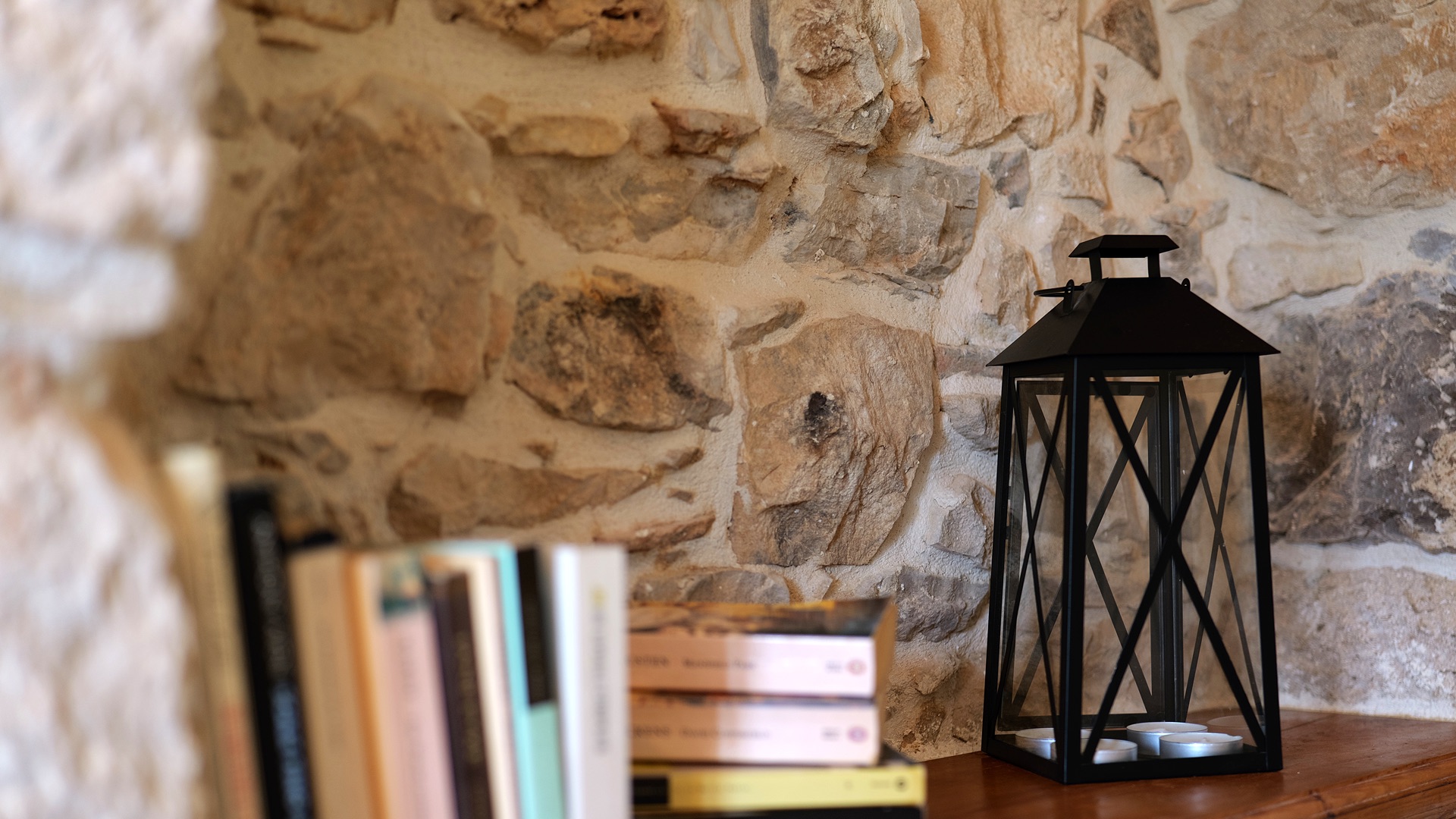 Stone wall detail — lantern & books