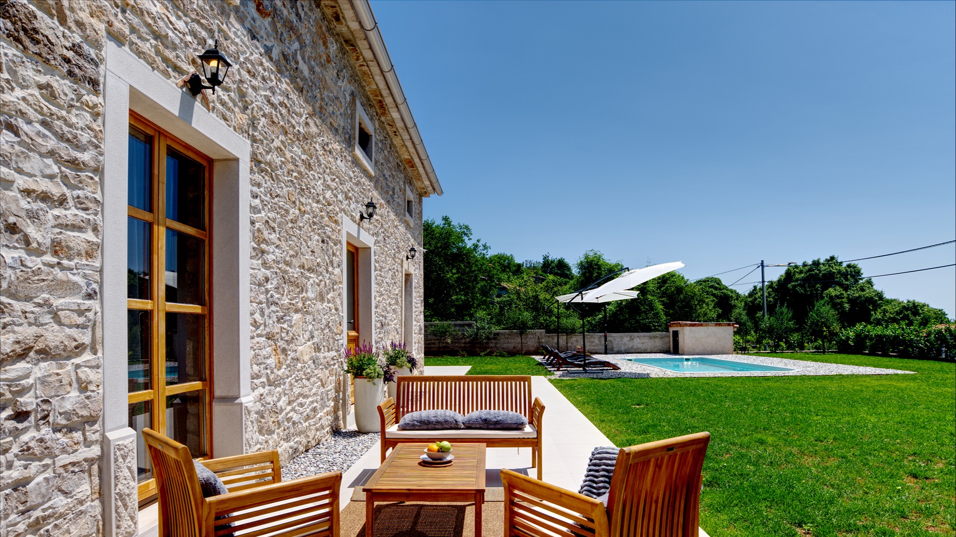 Terrace lounge area by the stone wall